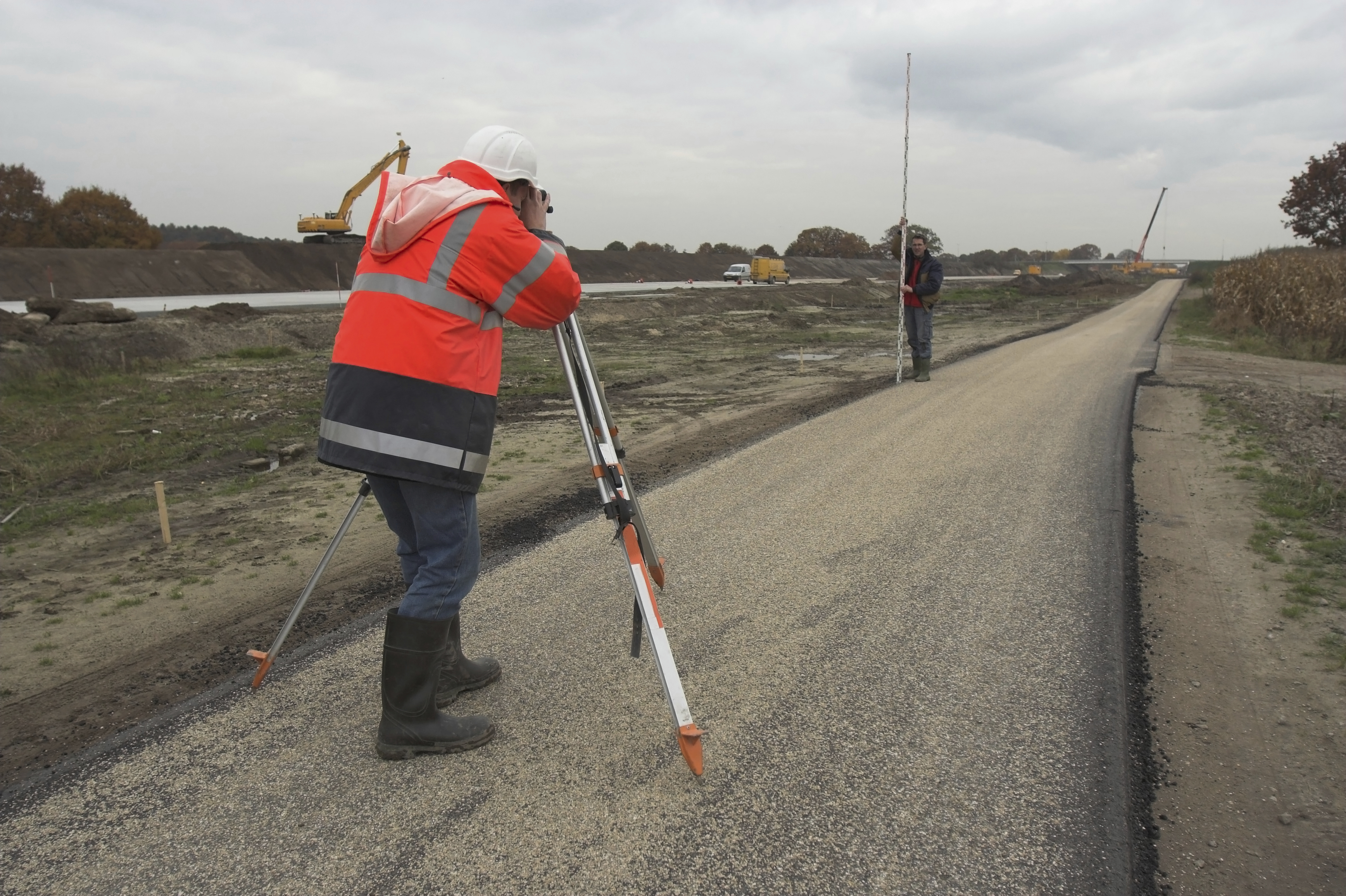 Image of a surveyor at work using an optical levelling instrument